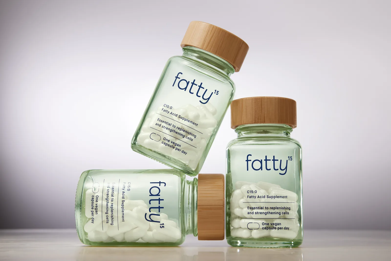 Three glass bottles of Fatty15 C15:0 supplement
