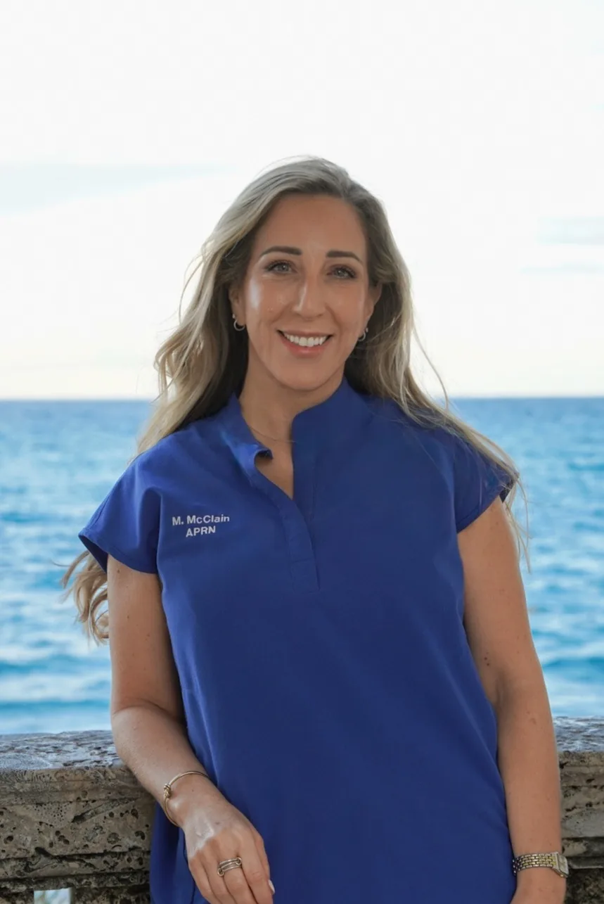 Maureen McClain, APRN, in her clinic scrubs by the ocean